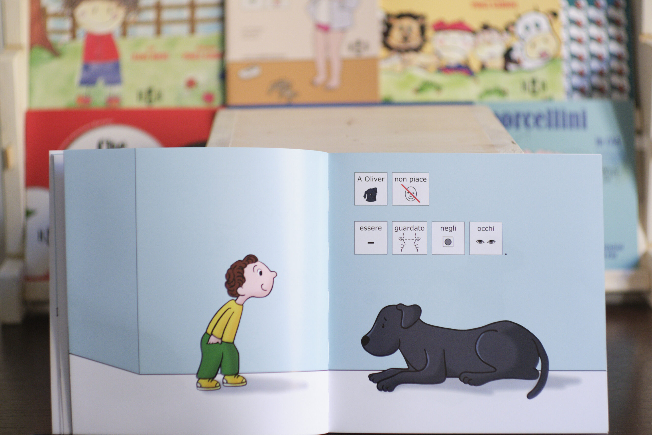 un libro in simboli aperto sull'illustrazione di un cane eun bambino