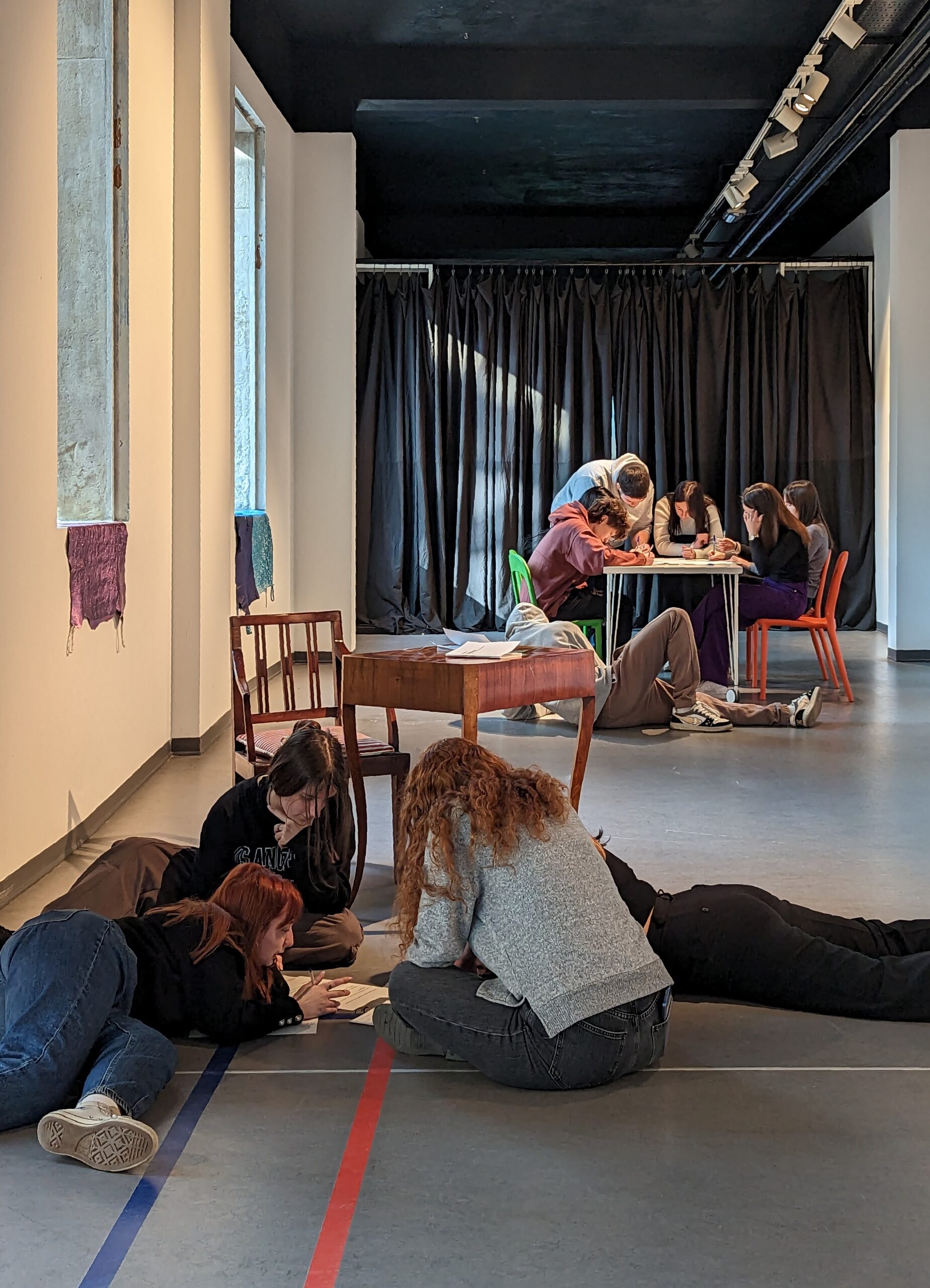 giovani svolgono un'attività all'interno di una mostra di arte contemporanea